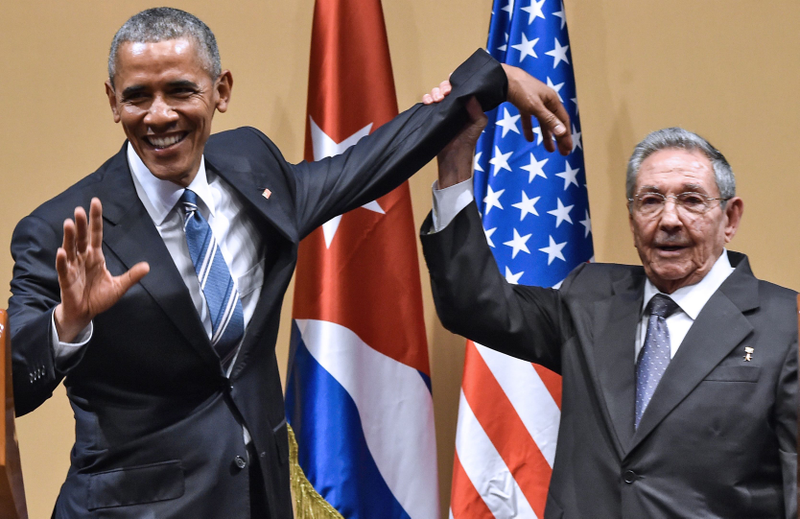 Cuban President Raúl Castro (right) raises U.S. President Barack Obama's hand during a meeting at the Revolution Palace in Havana on March 21, 2016. NICHOLAS KAMM/AFP/Getty Images